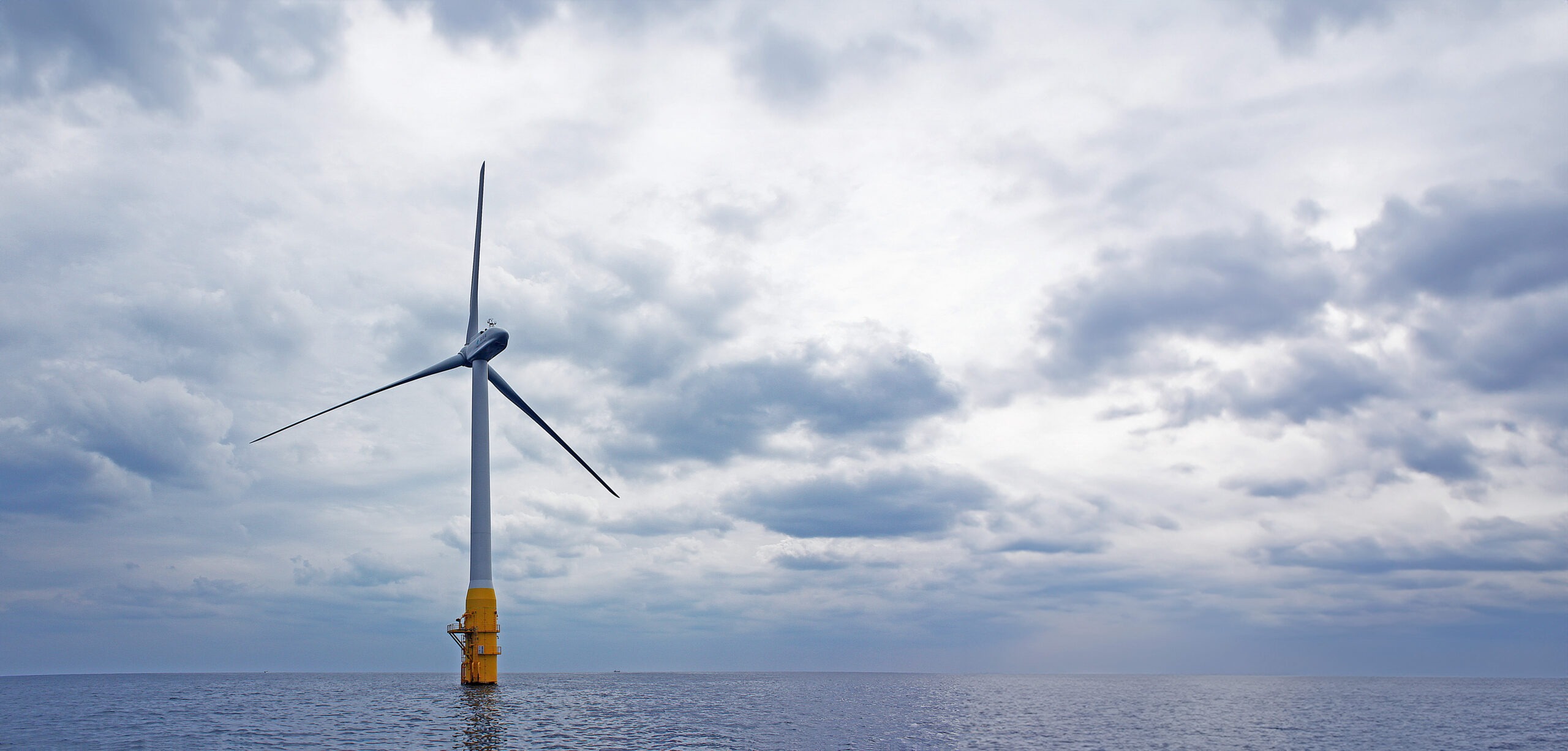 A wind turbine against a cloudy sky