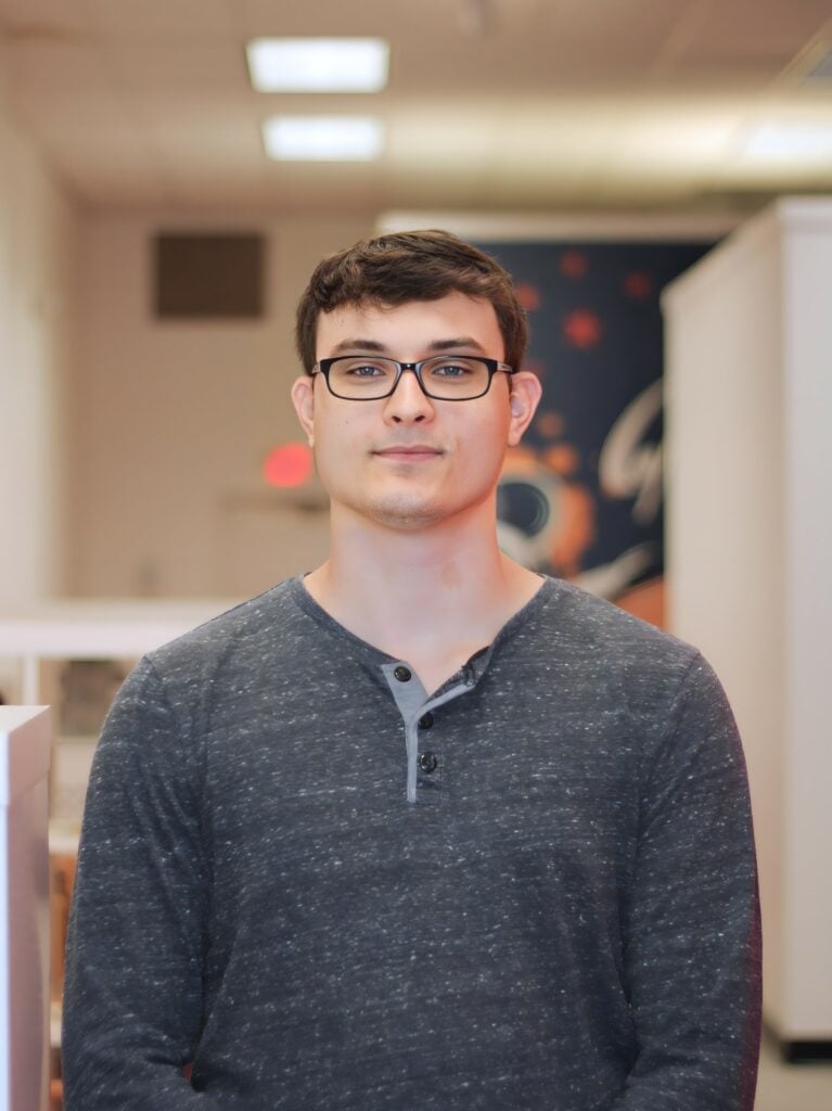 Christian Drury stands near the entrance to the Datachieve Digital office