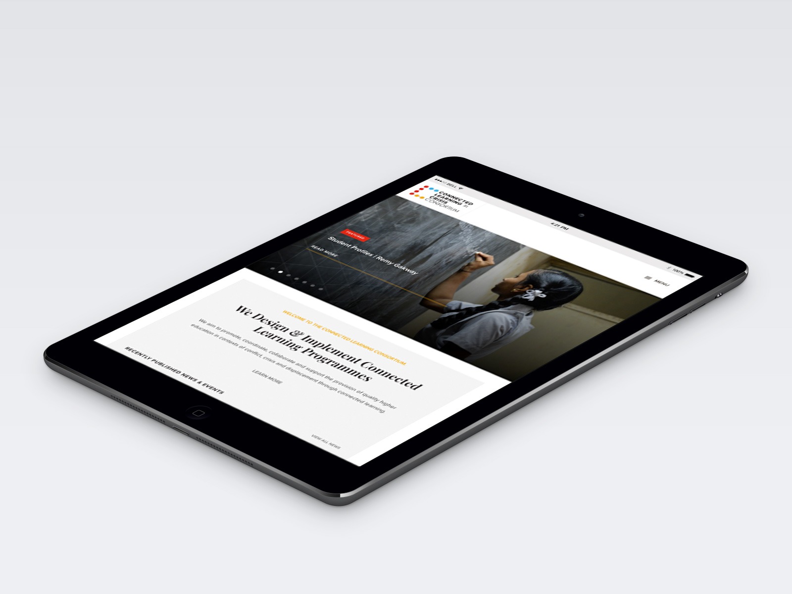 A tablet displaying a website with an image of a person writing on a chalkboard. The text on the screen reads about creating impactful content and monetizing it effectively. The tablet is angled on a light gray surface.