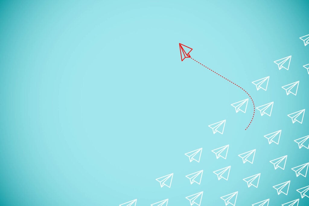 An abstract image of a paper airplane flying through a blue field