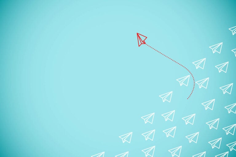 An abstract image of a paper airplane flying through a blue field