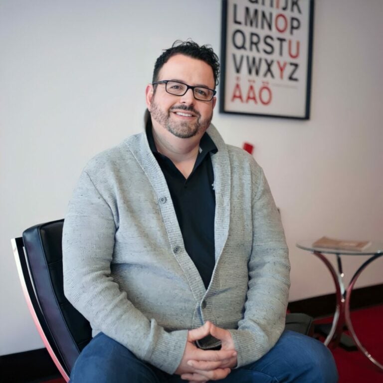 Shannon Myers sits near the entrance to the Datachieve Digital office